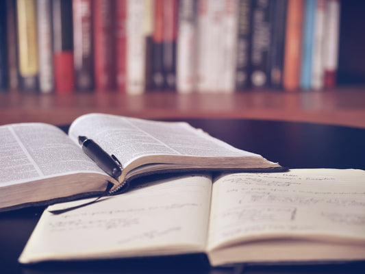 Stack of Cambridge IGCSE textbooks on a study desk